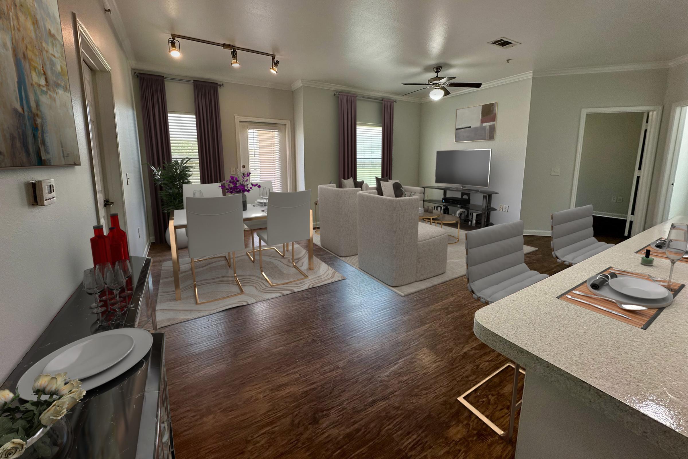 A modern living and dining area featuring a light-colored sofa and chairs, a dining table set for four, and a flat-screen TV. The space is well-lit with natural light, has wood flooring, and decorative elements like artwork and plants, creating a welcoming atmosphere.