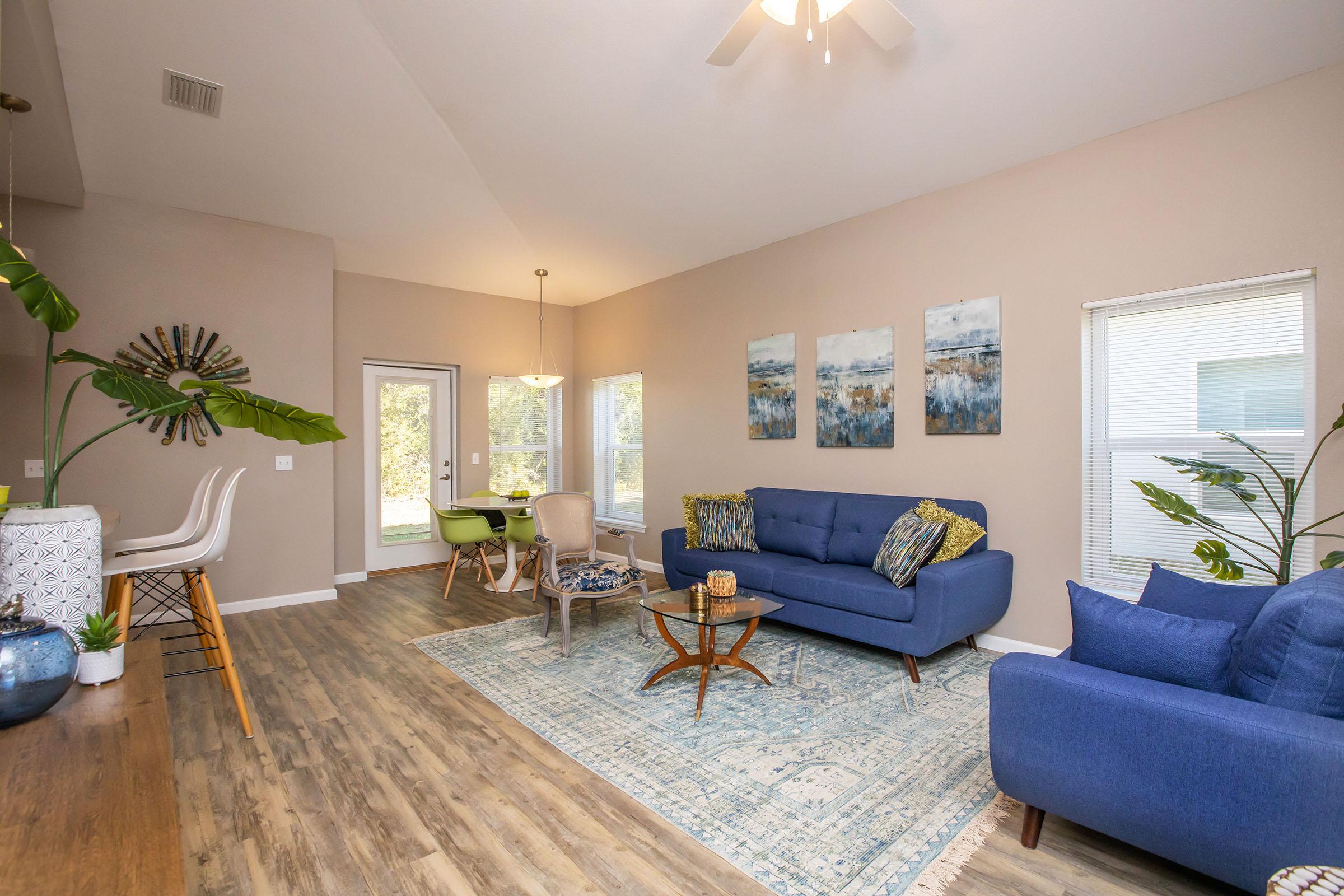 a living room filled with furniture and a large window