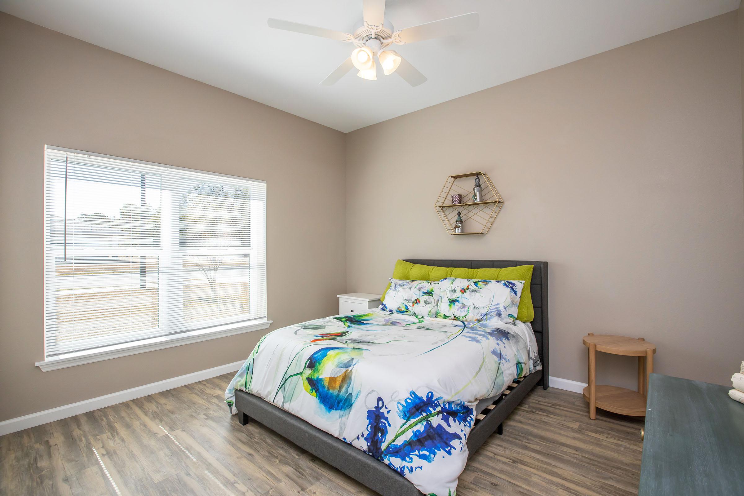 a bedroom with a bed and a couch in a living room