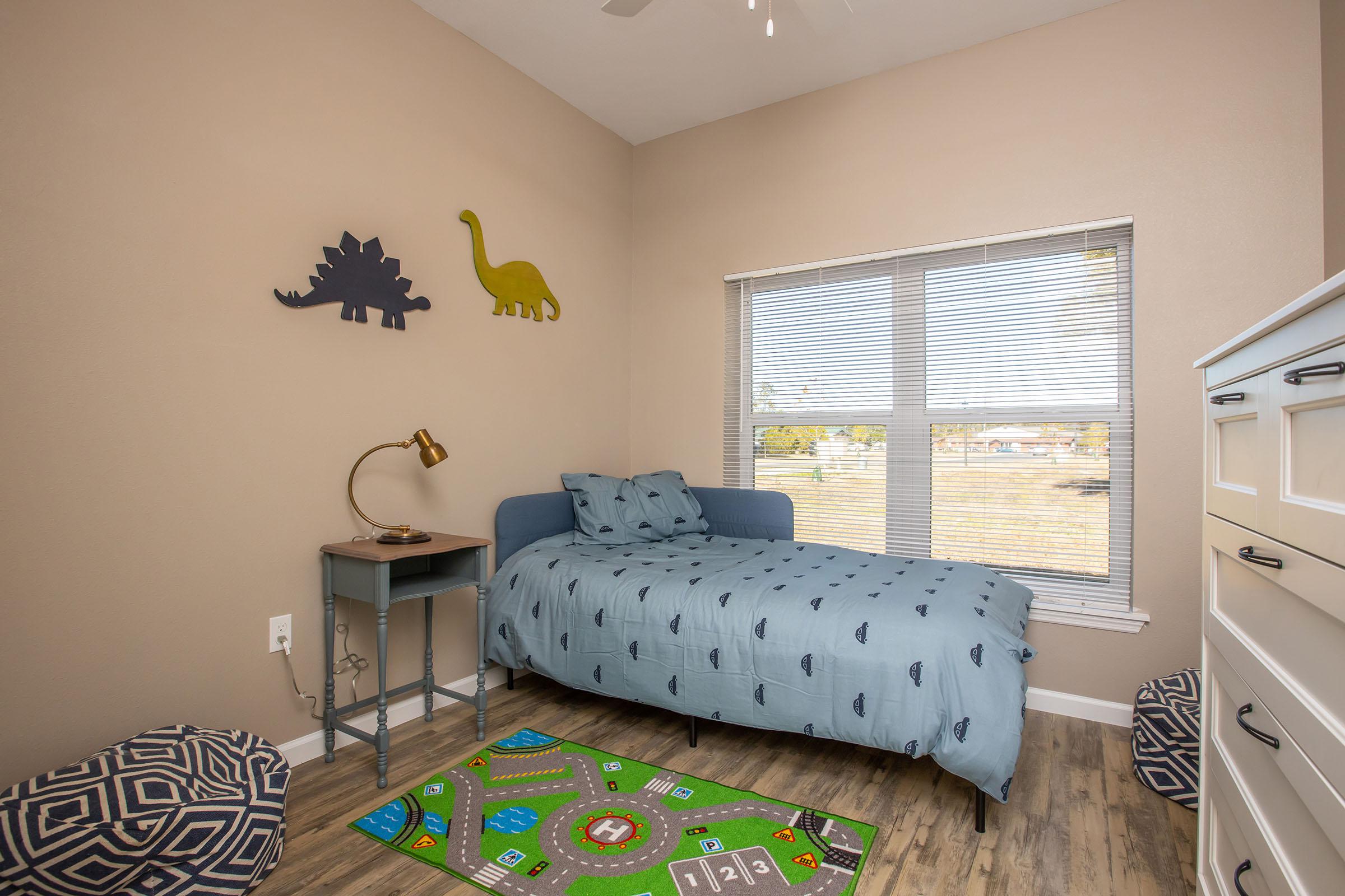 a bedroom with a bed and desk in a room