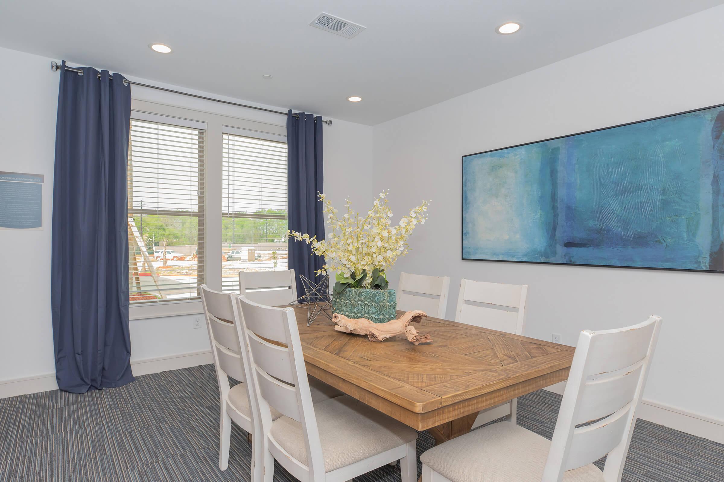 a living room filled with furniture and a large window