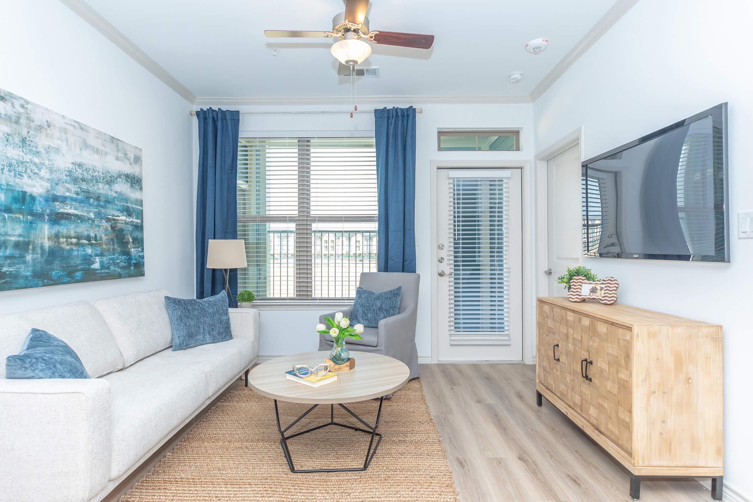 a living room filled with furniture and a large window