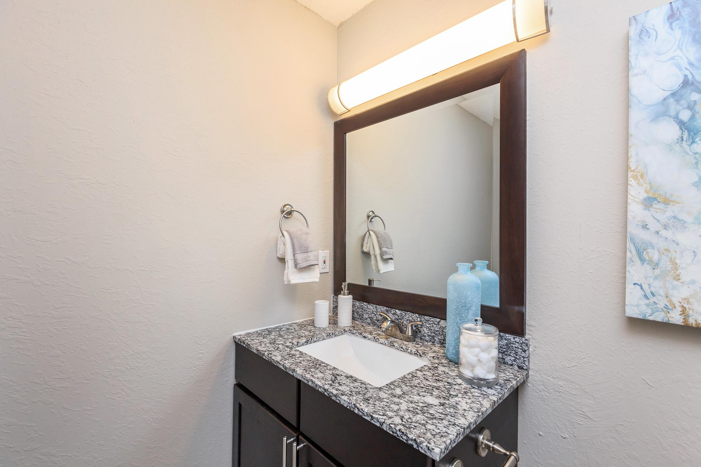 a room with a sink and a mirror