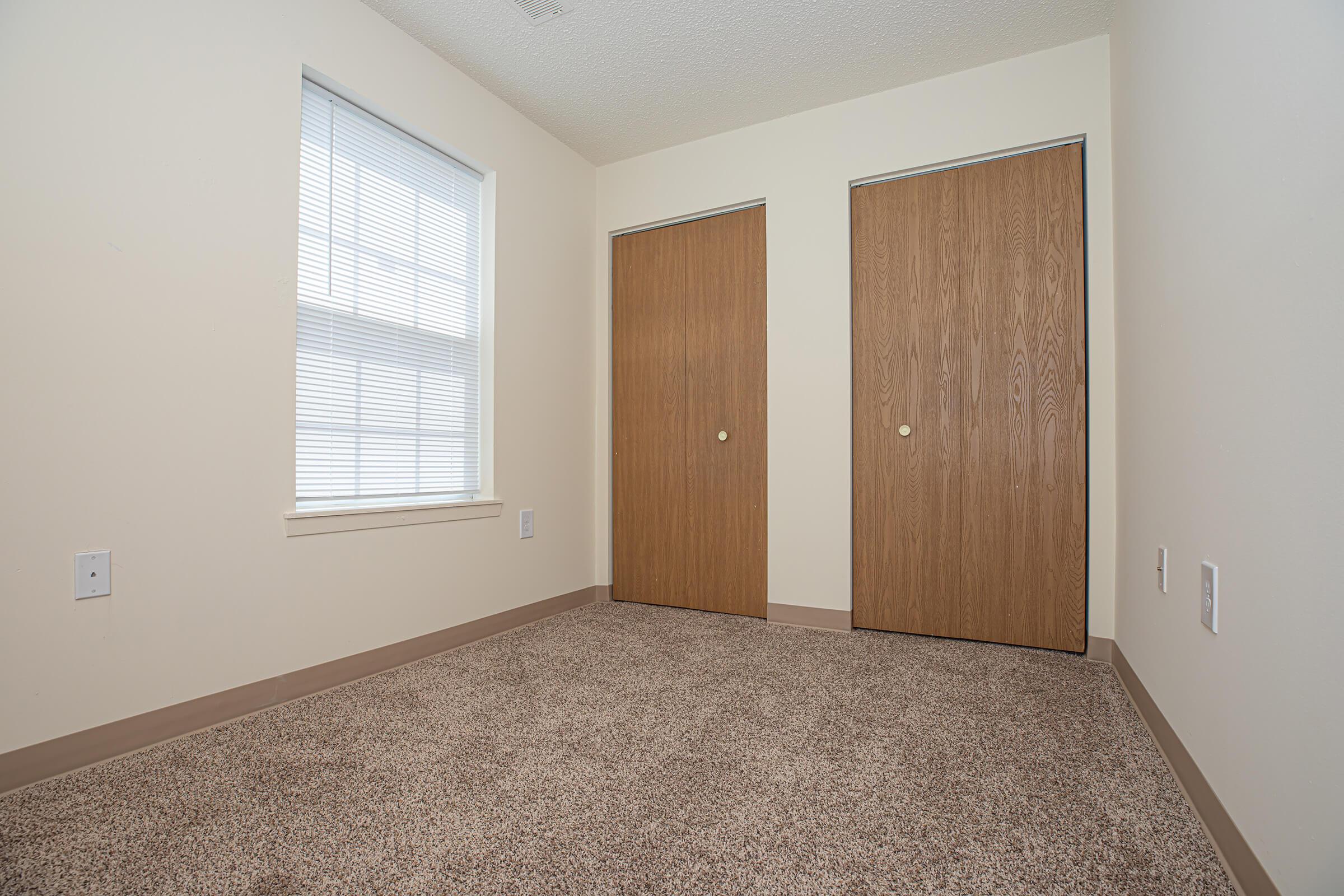 a bedroom with a bed in a small room