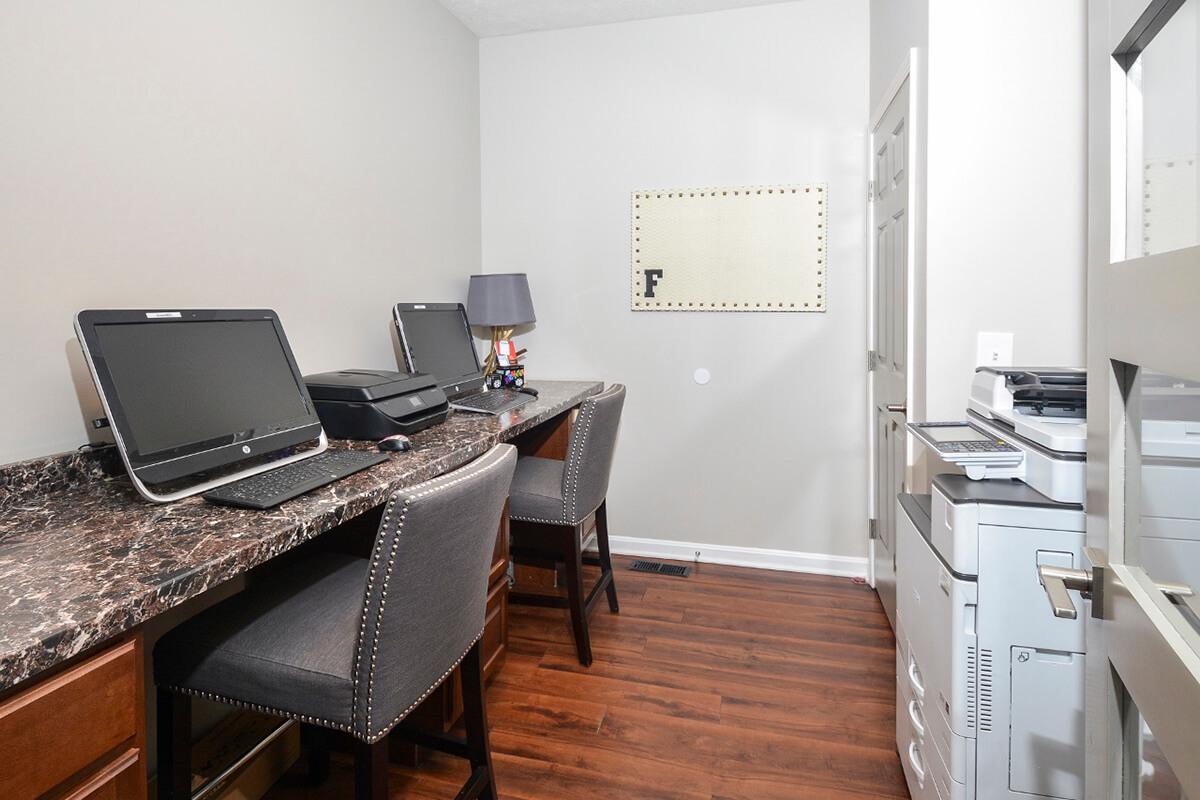 a desk with a laptop computer sitting on top of a table