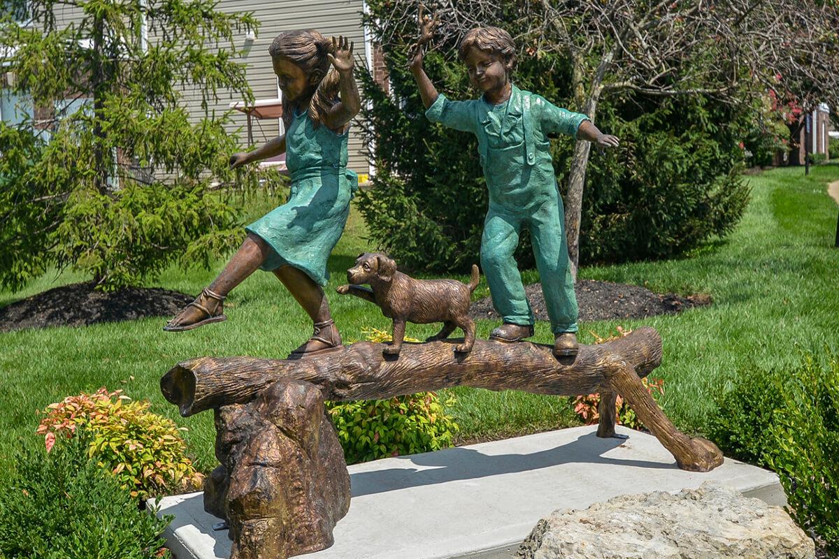 a statue of a person in a garden
