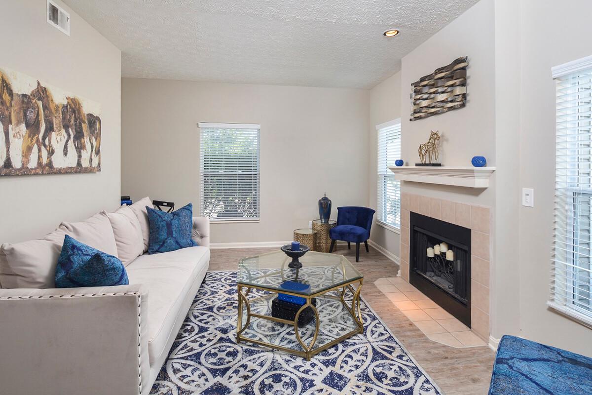 a living room filled with furniture and a fireplace