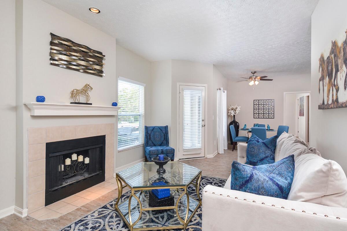 a living room filled with furniture and a fireplace