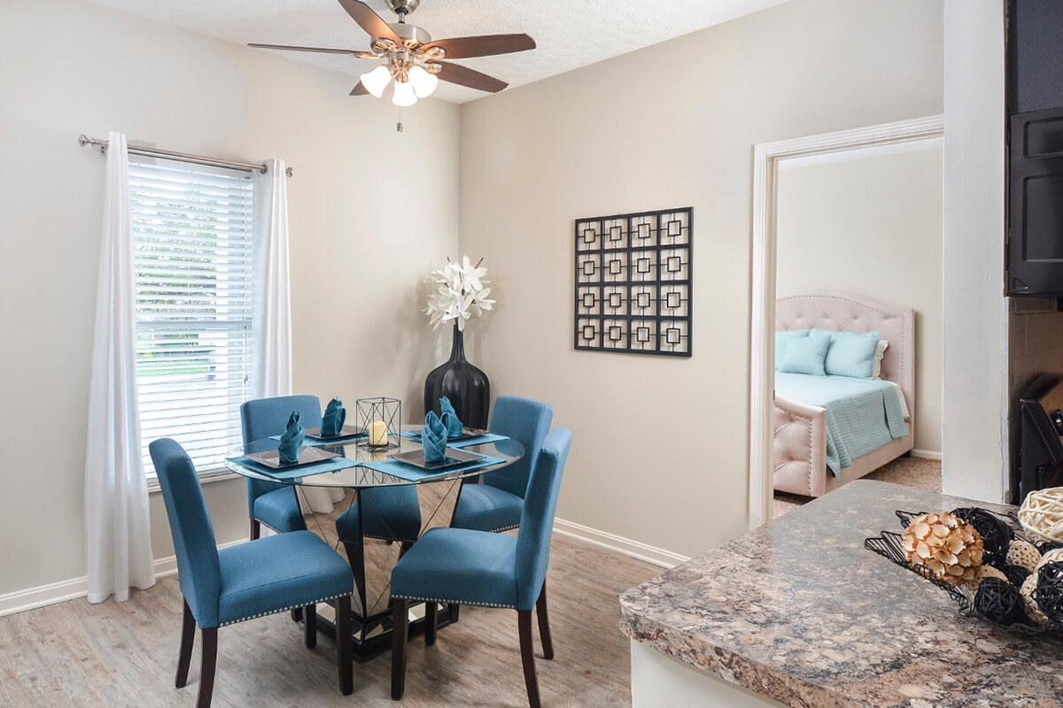 a living room filled with furniture and a large window