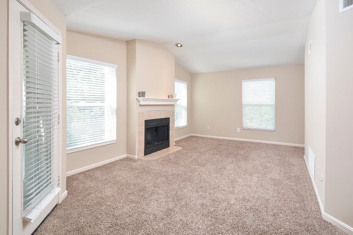 a living room filled with furniture and a large window