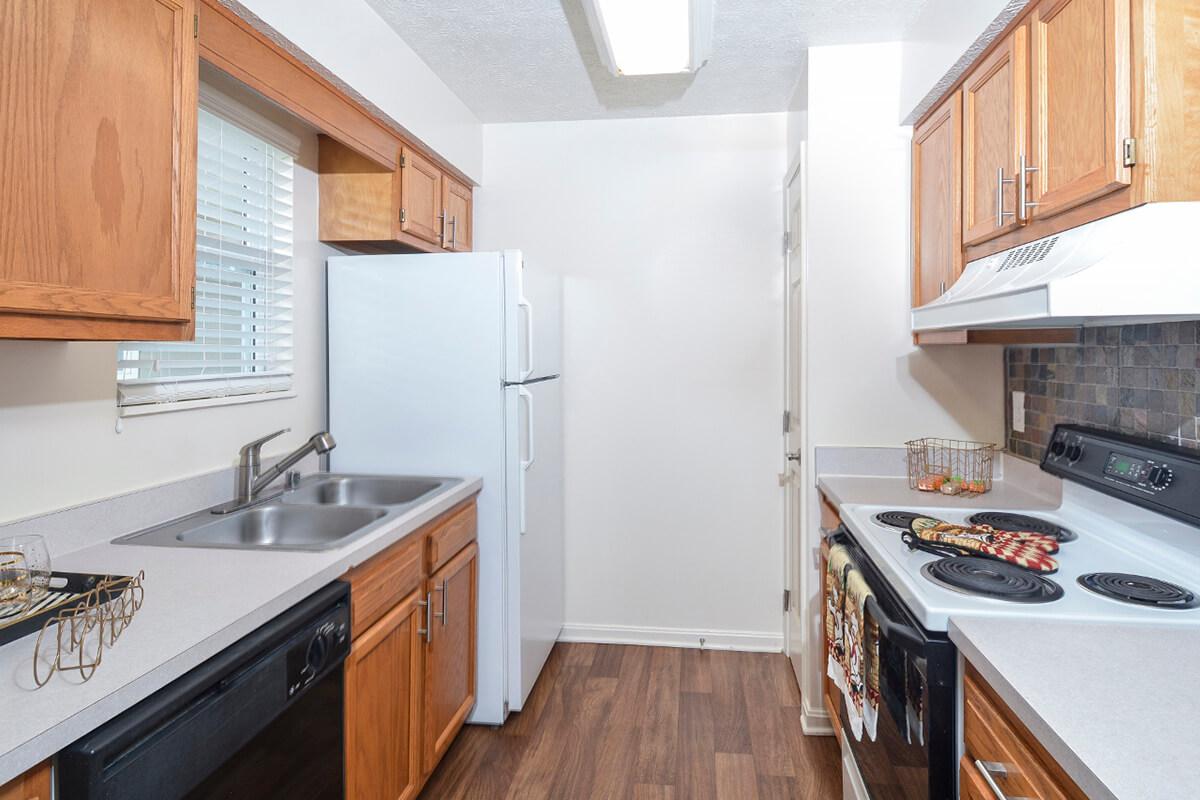 a kitchen with stainless steel appliances and wooden cabinets