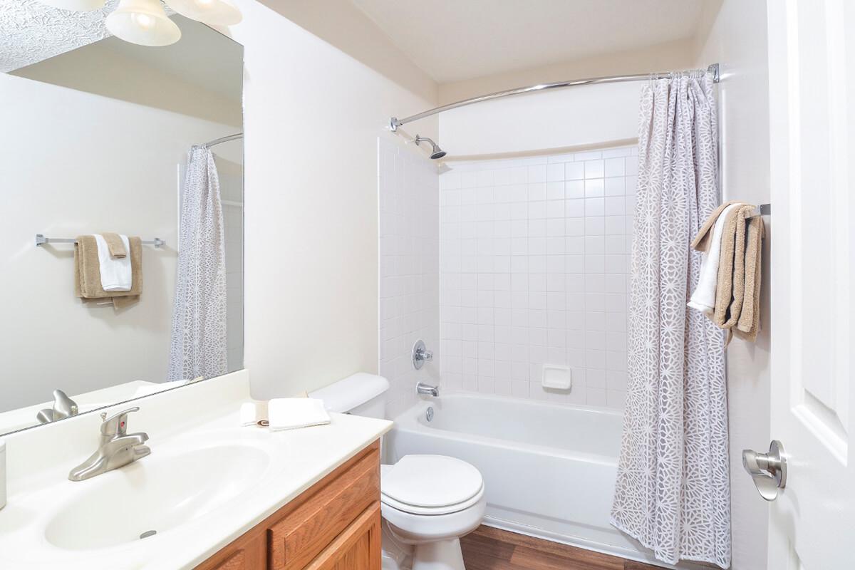 a white sink sitting next to a shower