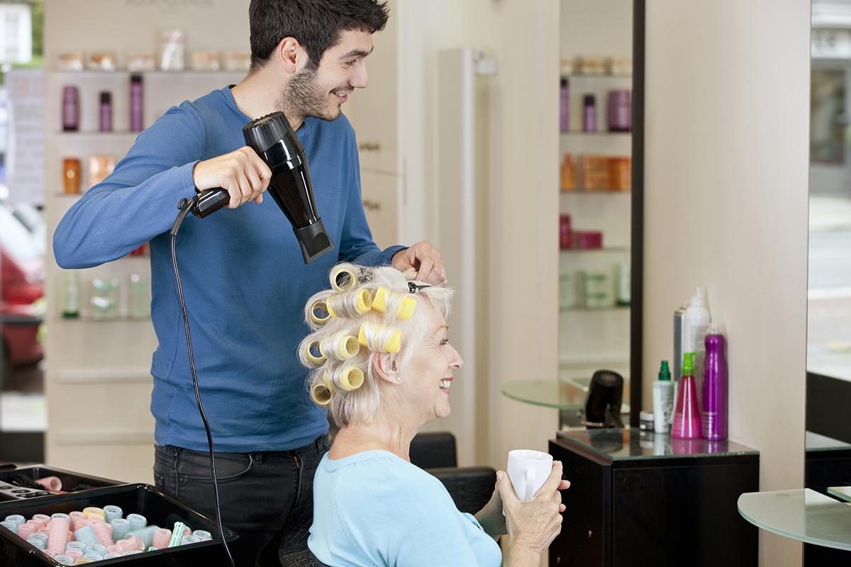 Senior woman having her hair dried.jpg