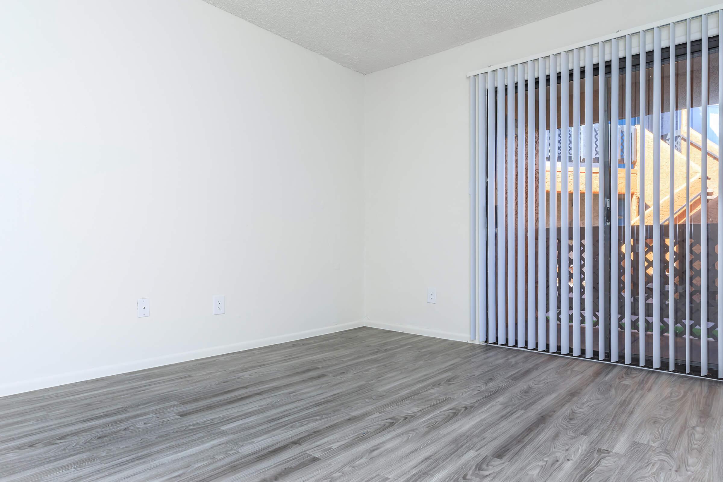 a bedroom with a building in the background