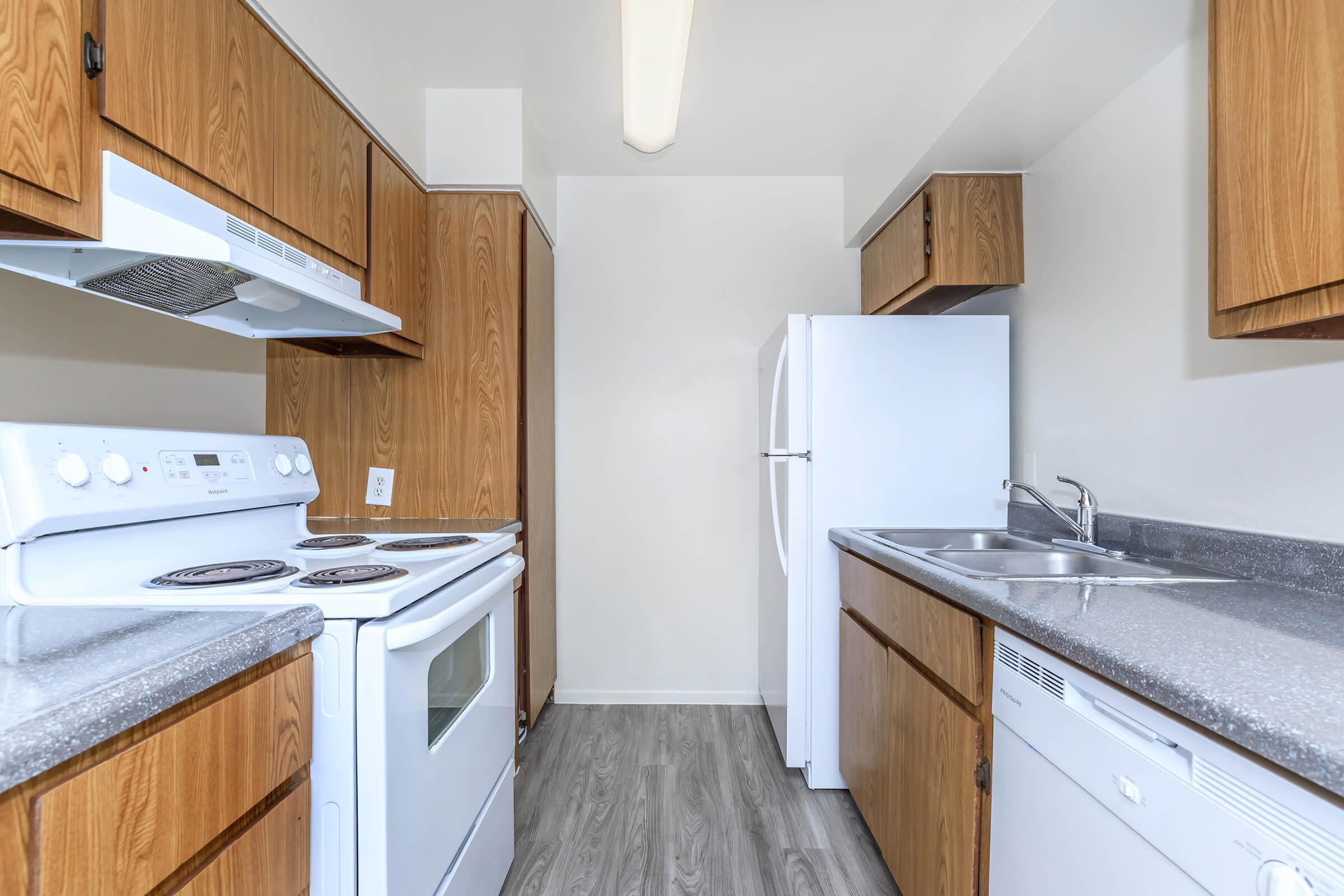 a kitchen with a stove sink and refrigerator