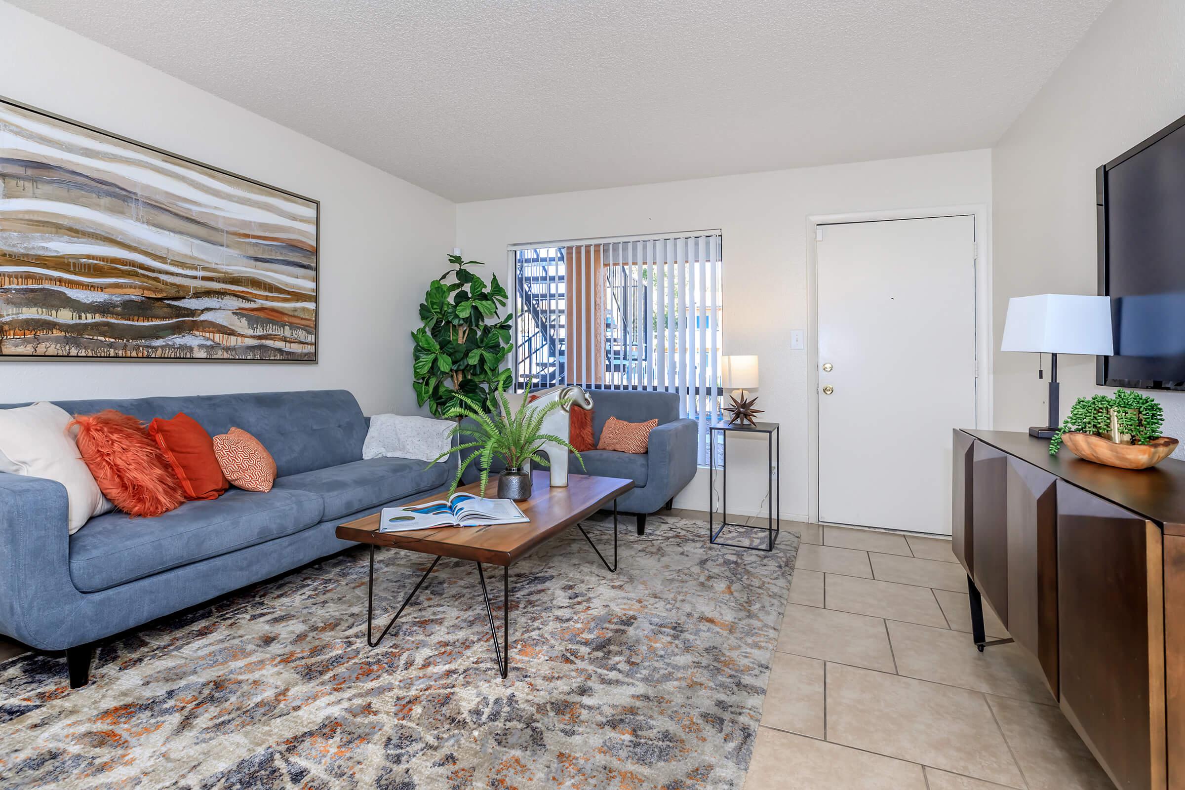 a living room filled with furniture and a flat screen tv