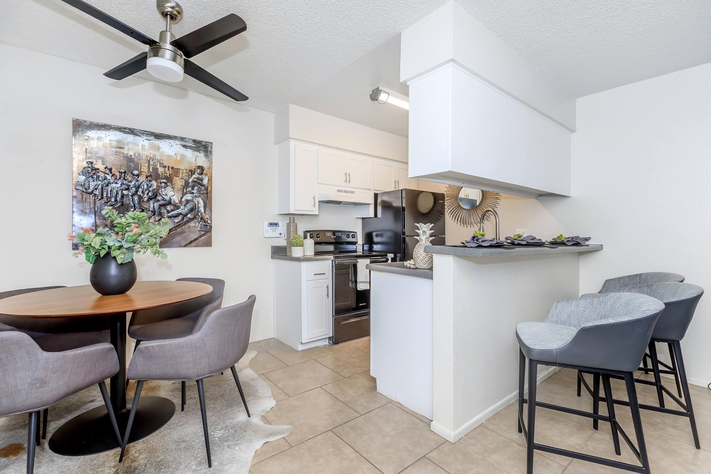 a kitchen area with a desk and chair in a room