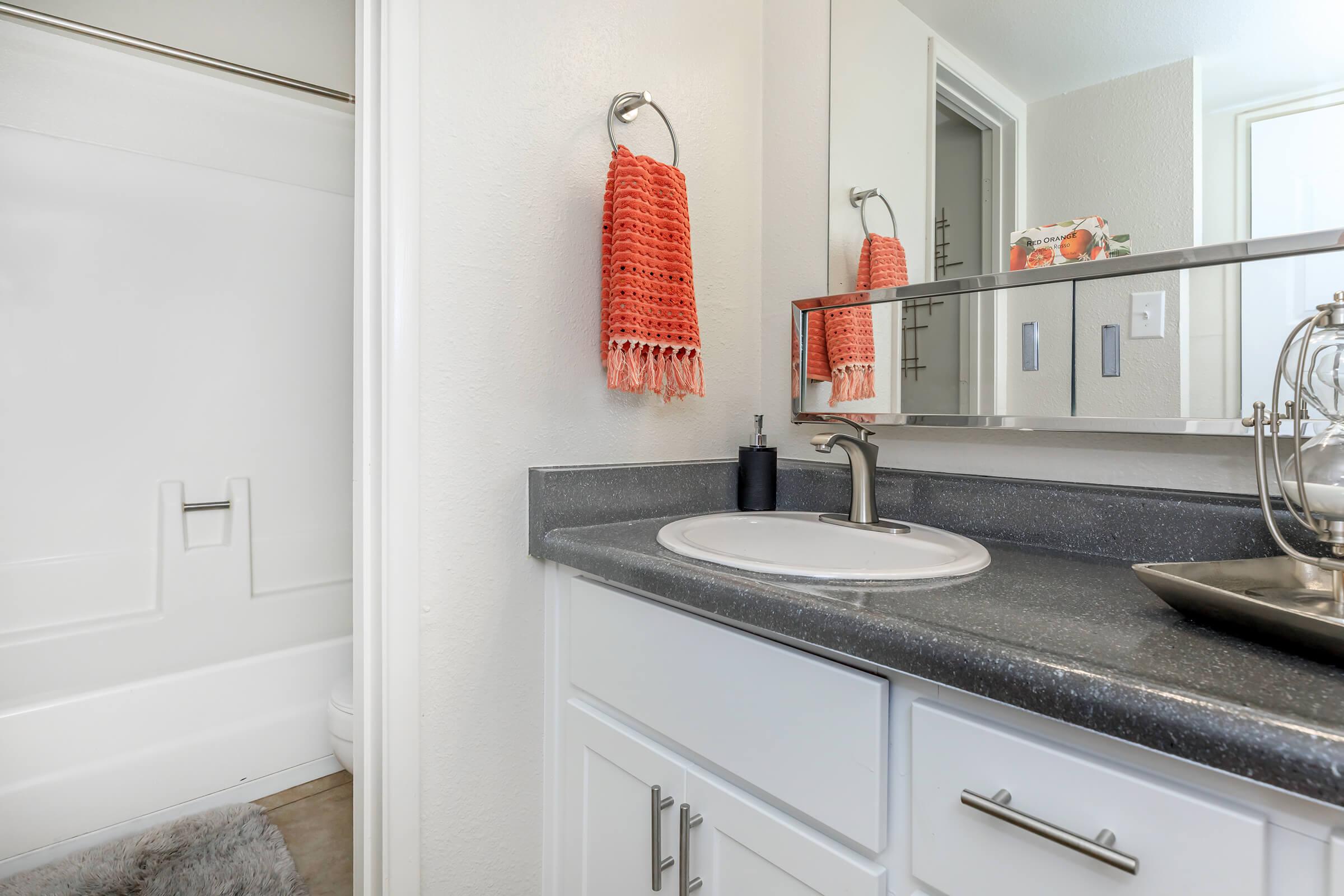 a kitchen with a sink and a mirror