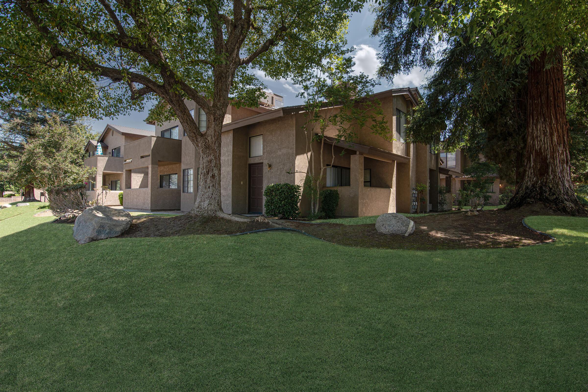 Community building with green grass and decortive rocks