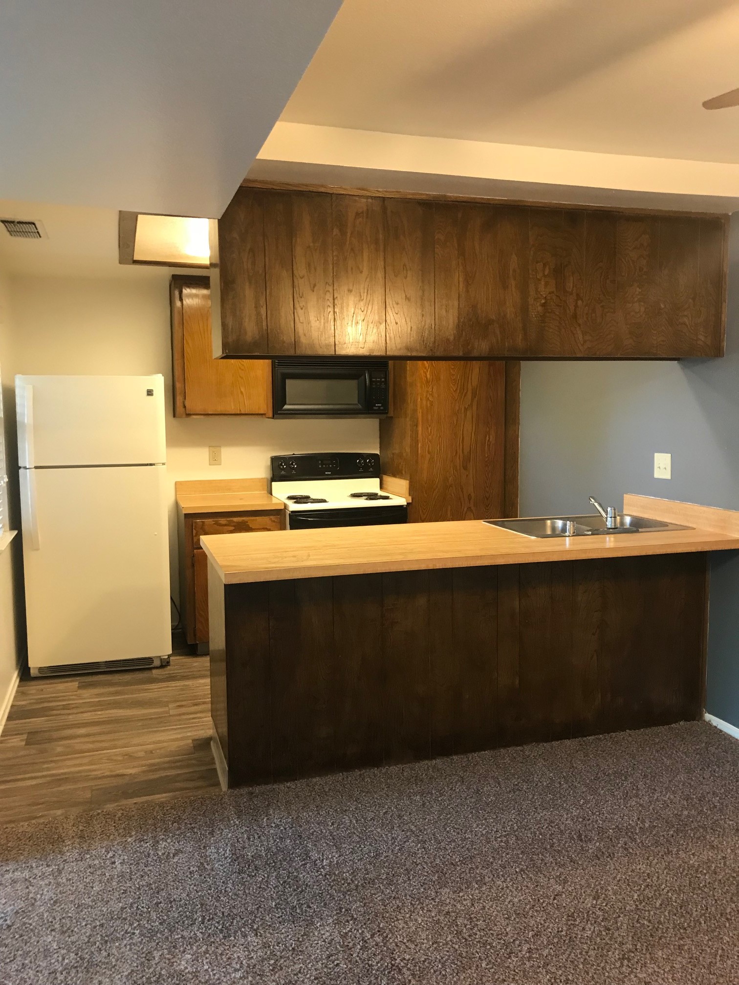 Kitchen with white appliances and wooden cabinets