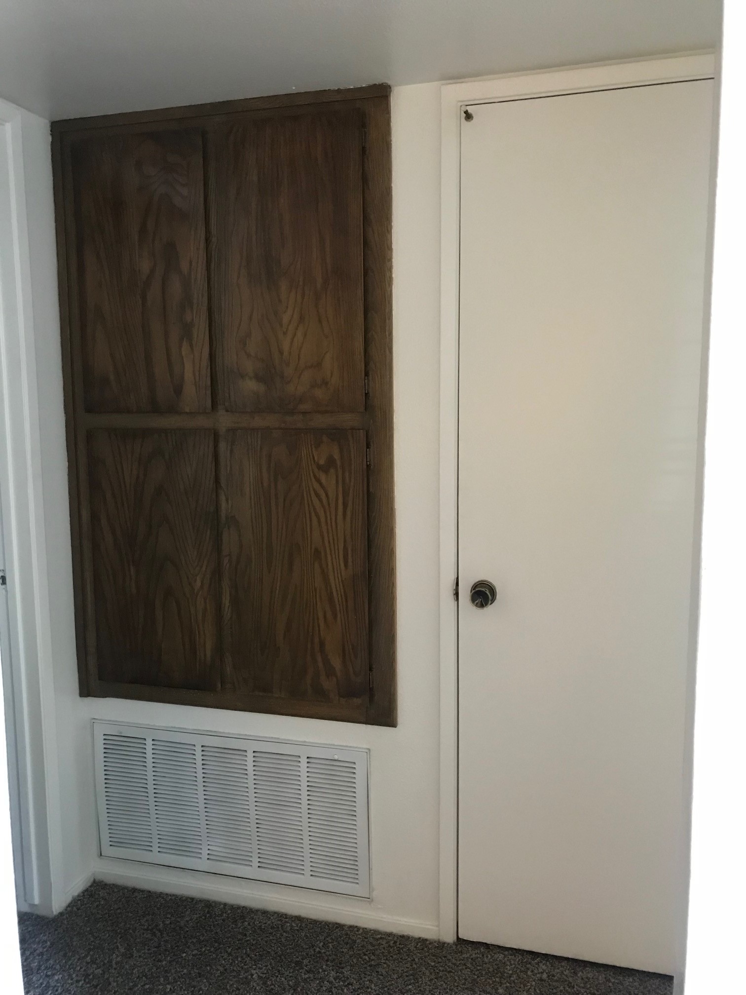a white refrigerator freezer sitting inside of a wooden door