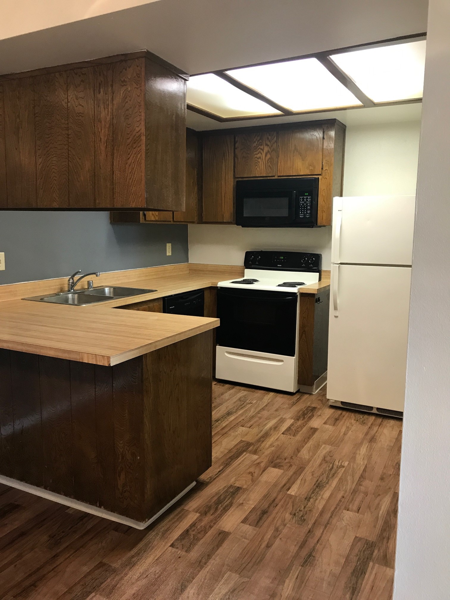 Vacant kitchen with wooden floors