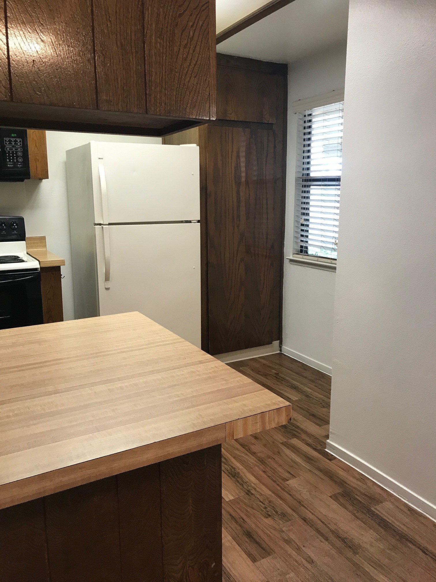 Vacant kitchen with wooden cabinets