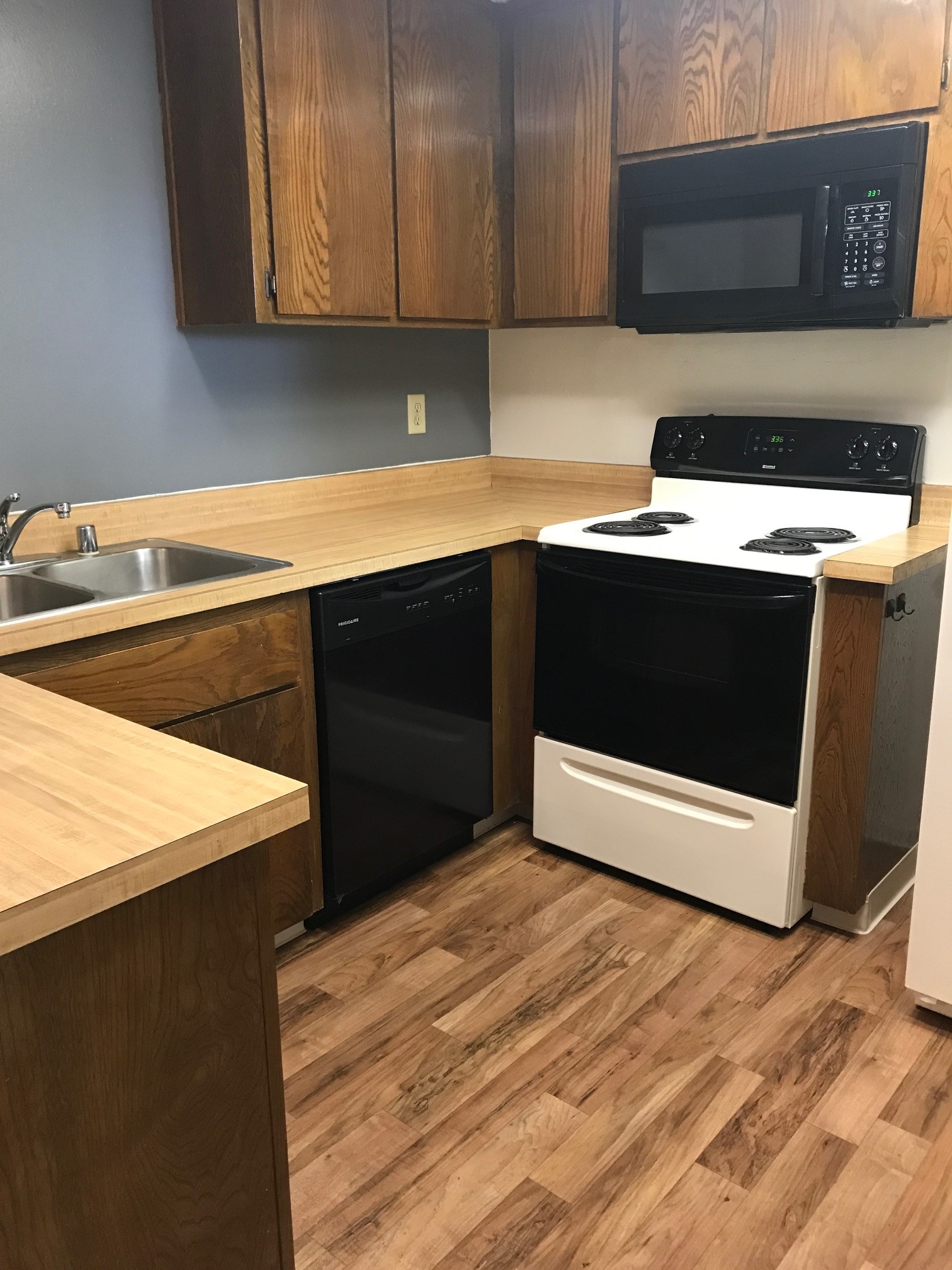 Vacant kitchen with black and white appliances