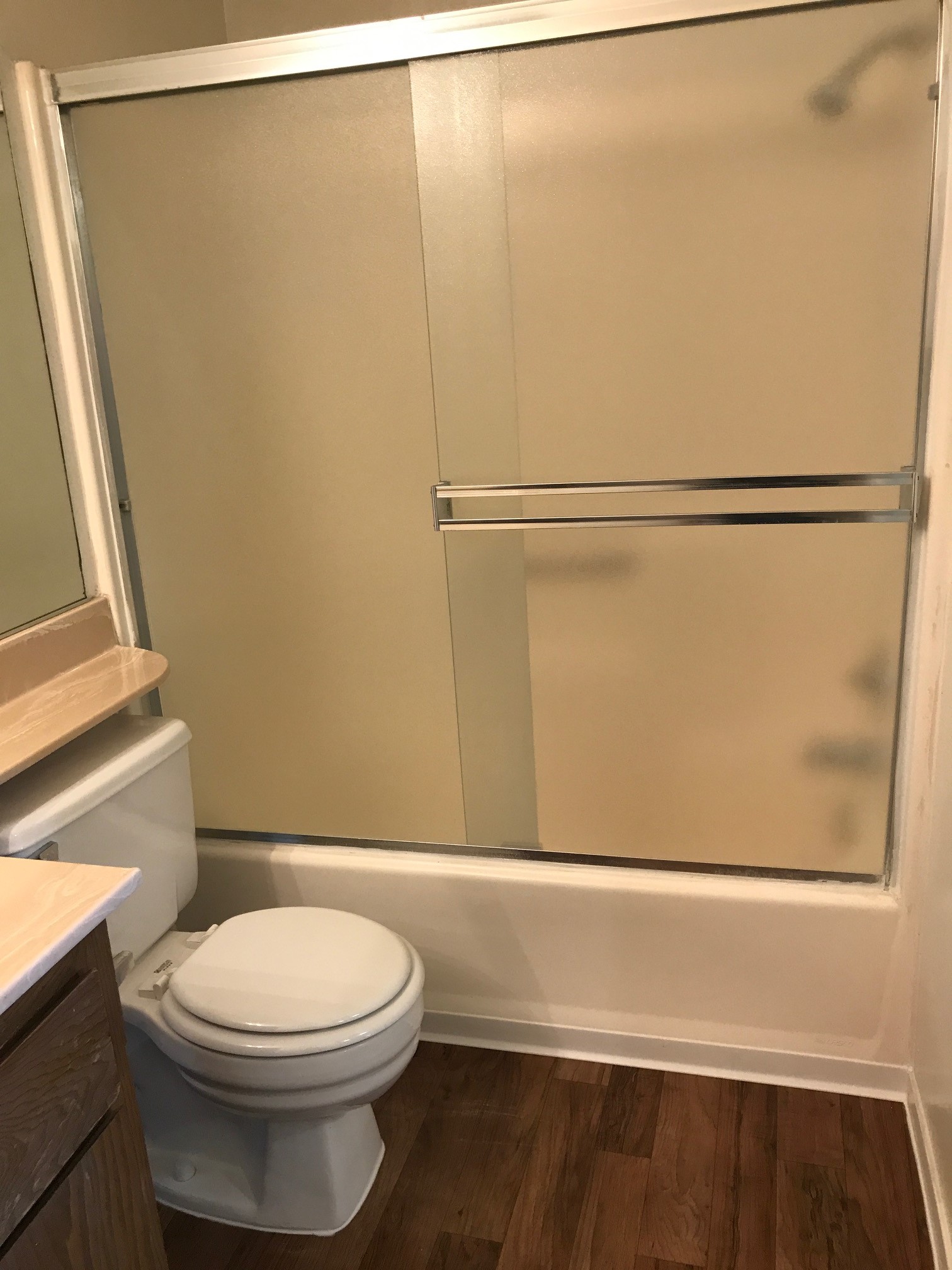 Vacant bathroom with wooden floors