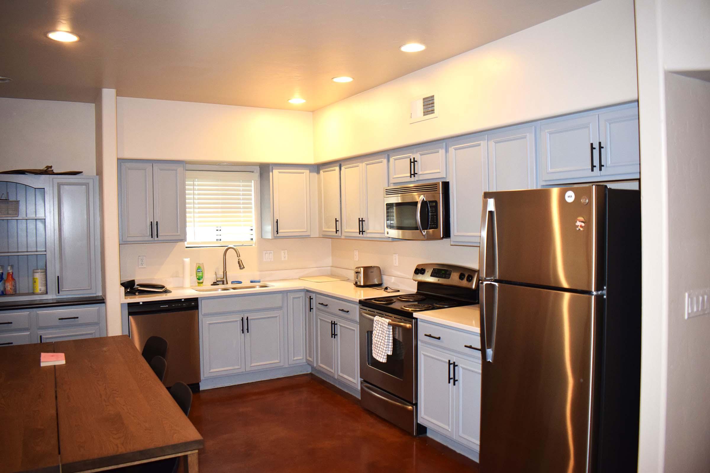 a kitchen with stainless steel appliances and wooden cabinets