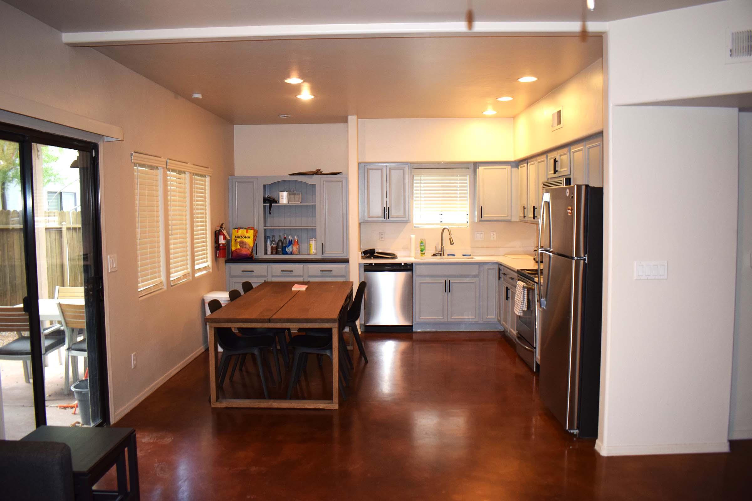 a modern kitchen with stainless steel appliances and wooden cabinets