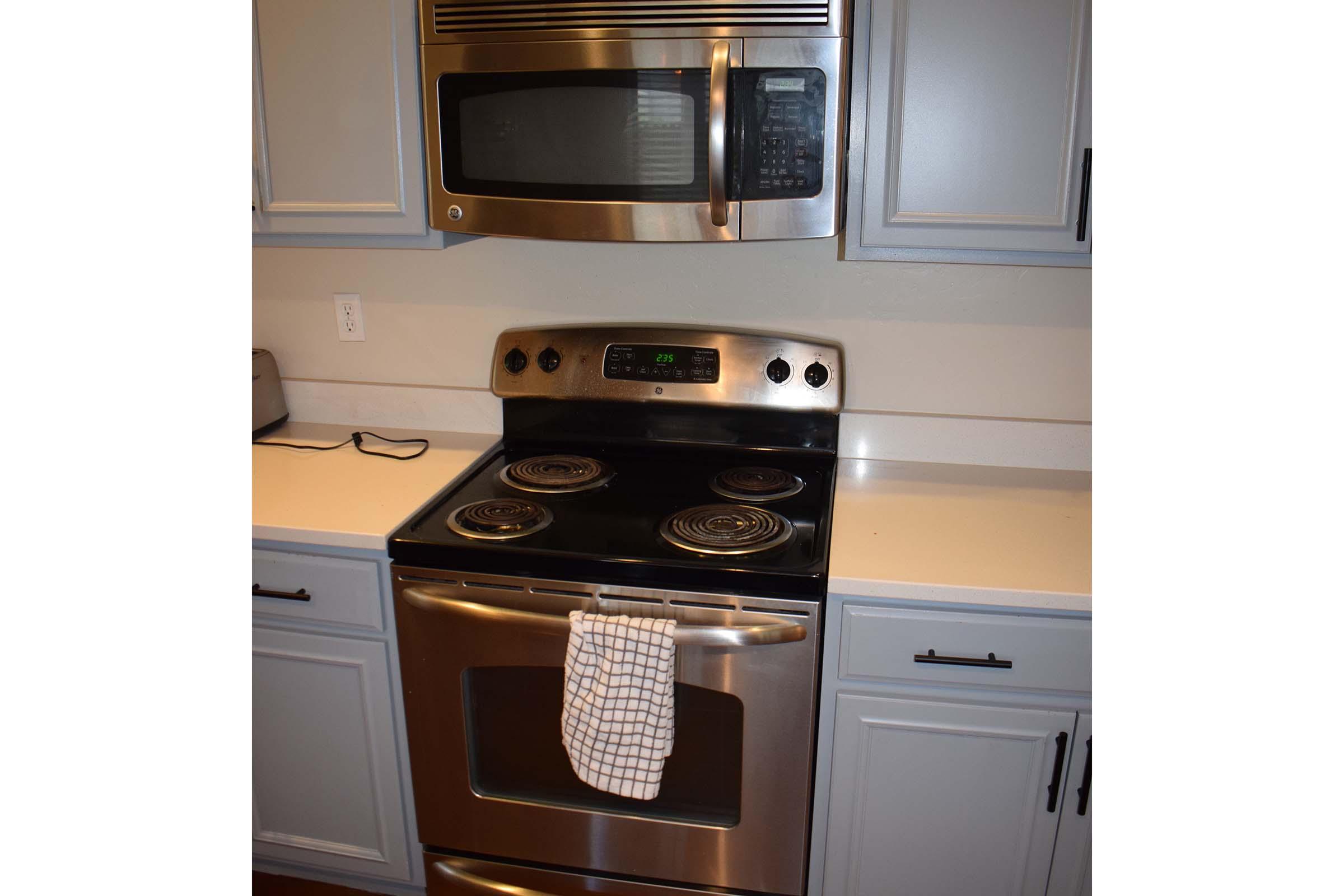 a microwave oven sitting on top of a stove