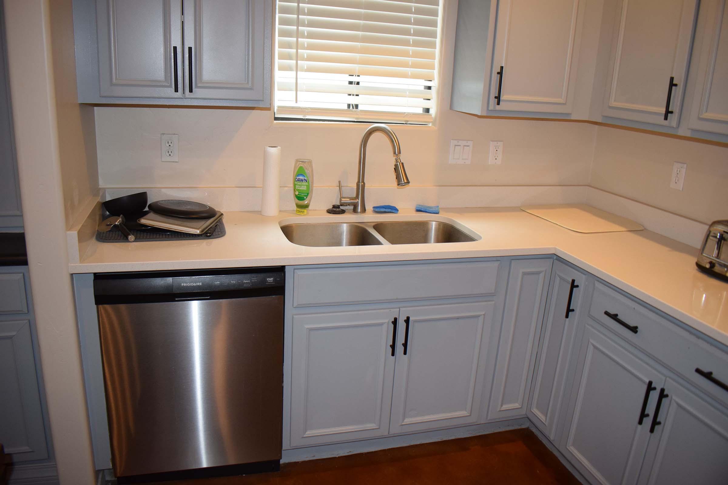 a kitchen with a stove a sink and a microwave