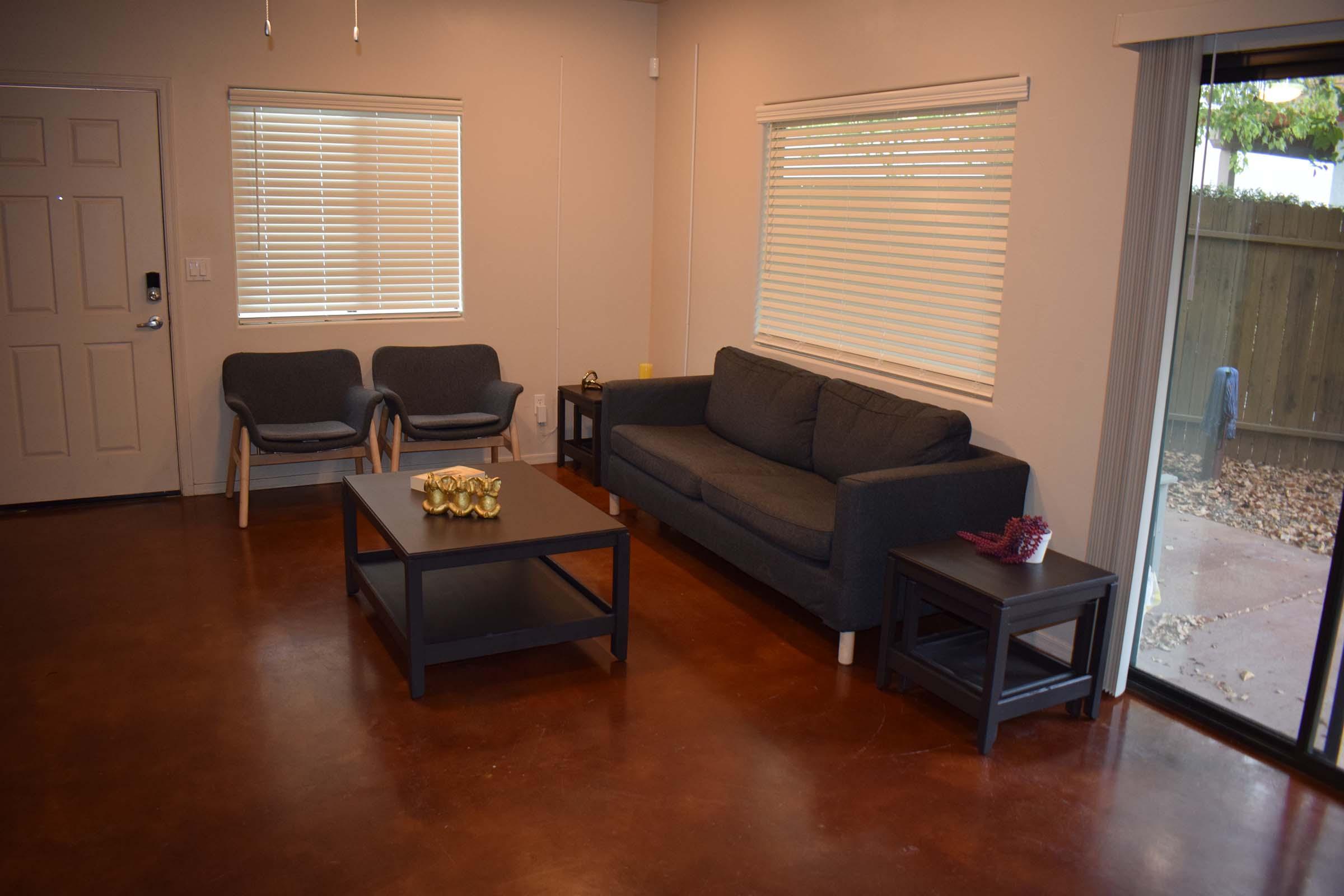 a living room filled with furniture and a large window