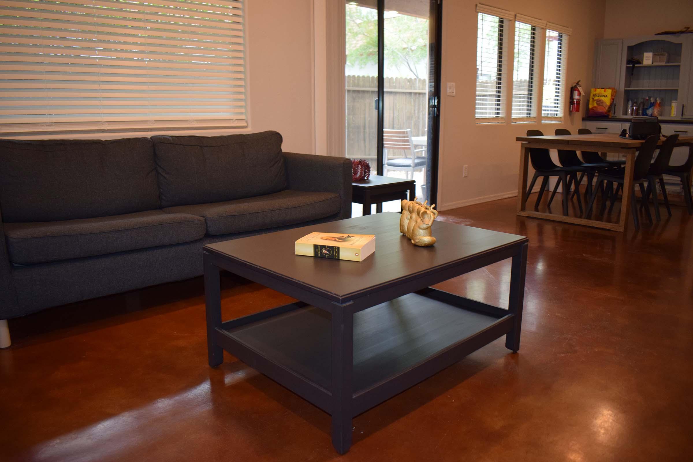 a living room filled with furniture and a large window