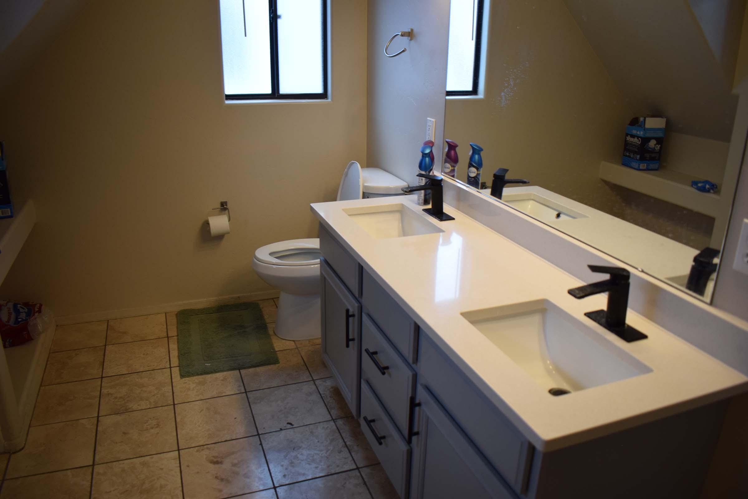 a kitchen with a sink and a mirror