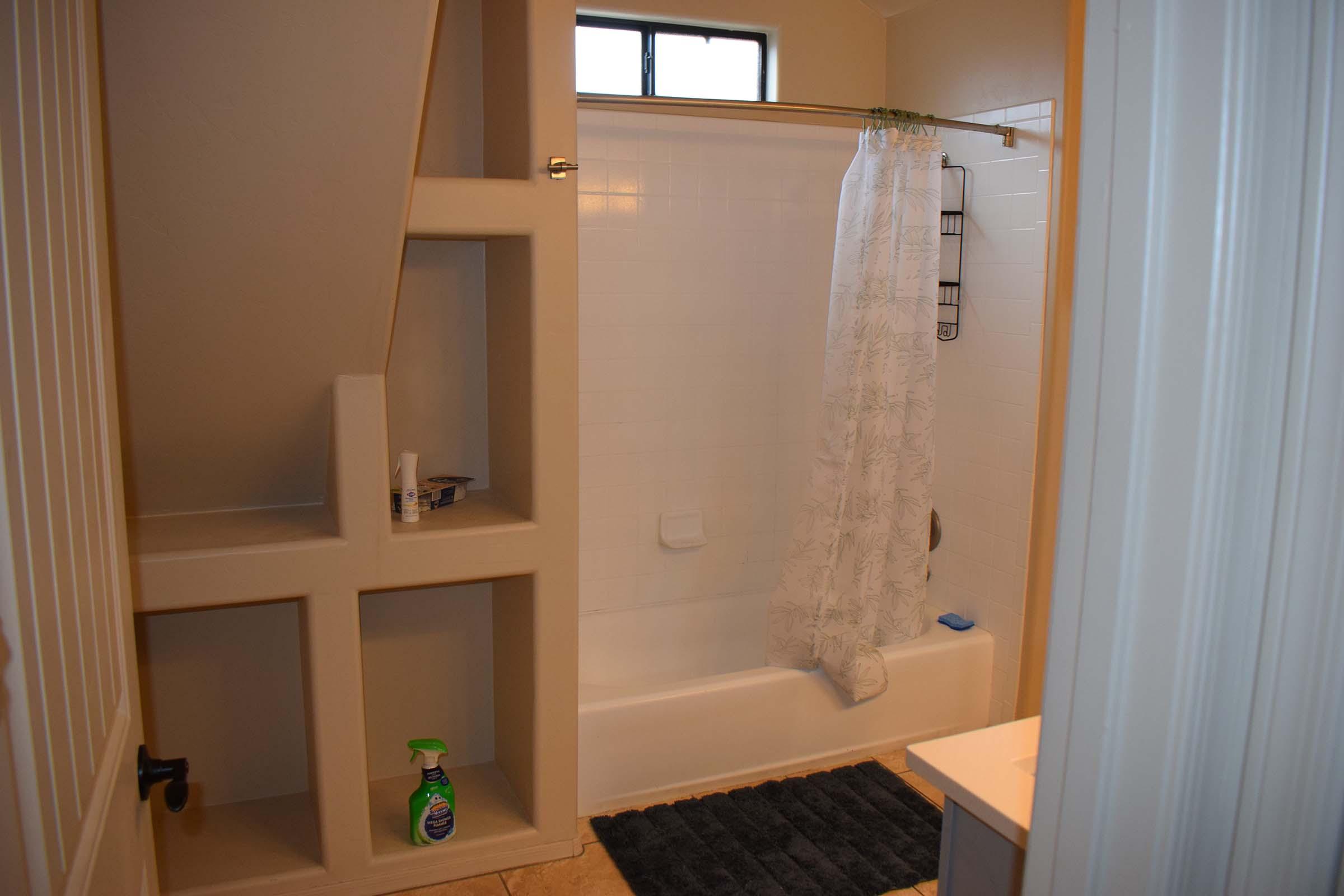 a shower that has a sink and a mirror