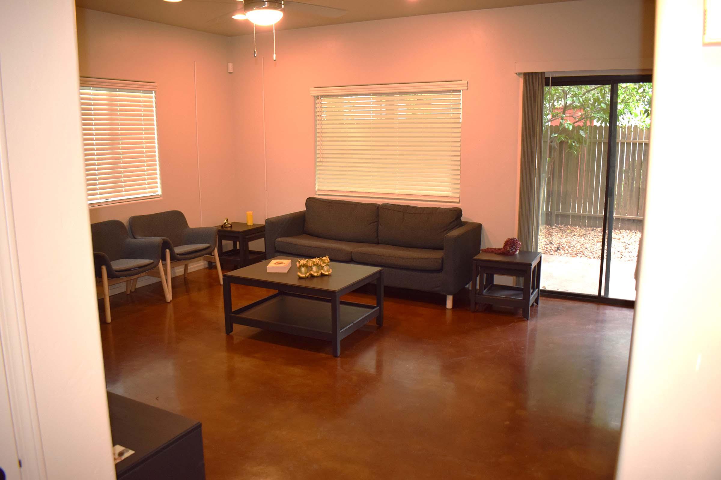 a living room filled with furniture and a large window