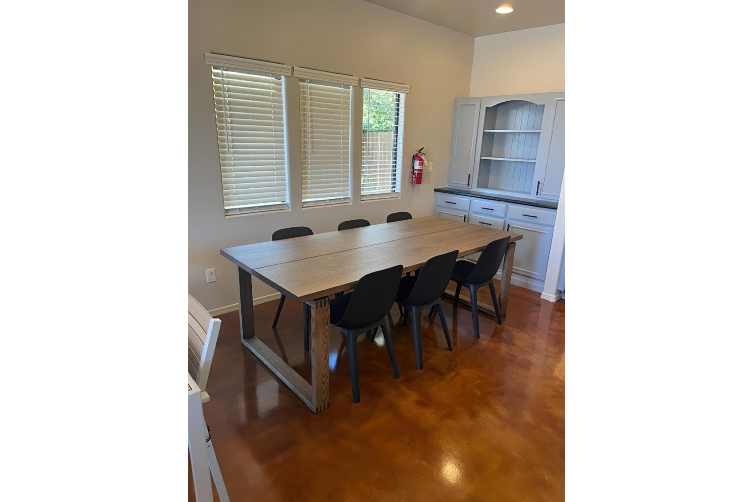 a dining room table in front of a window