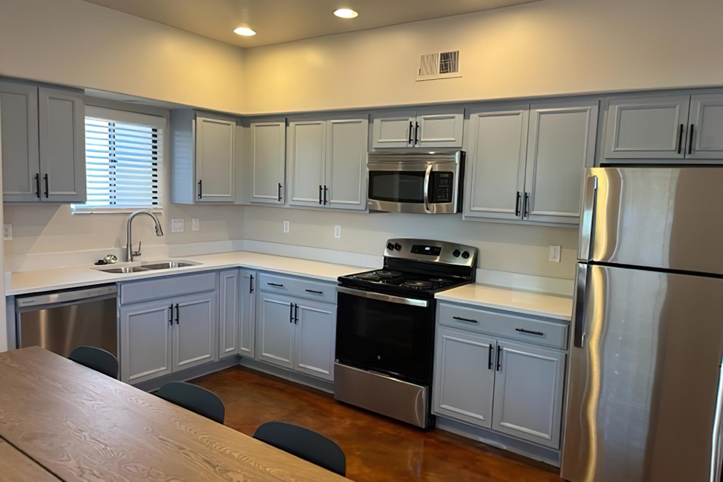 a large kitchen with stainless steel appliances