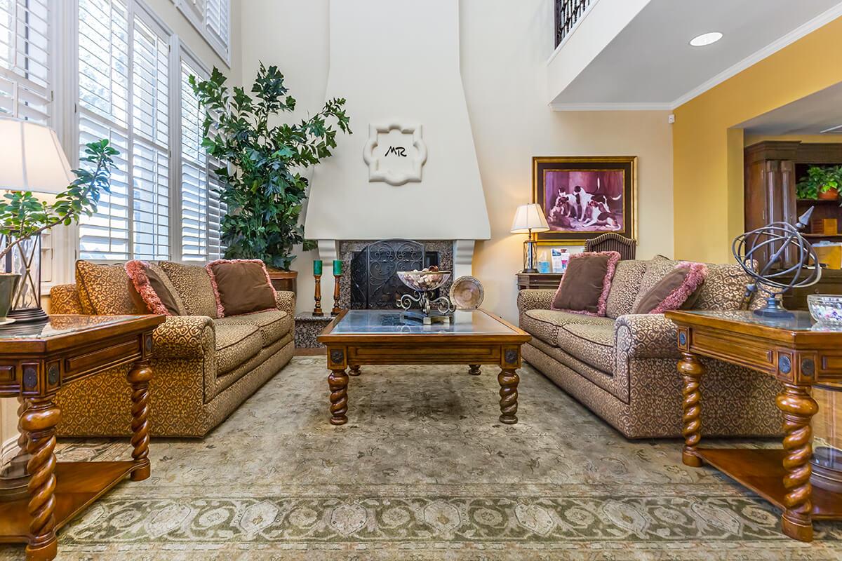 a living room filled with furniture and a large window