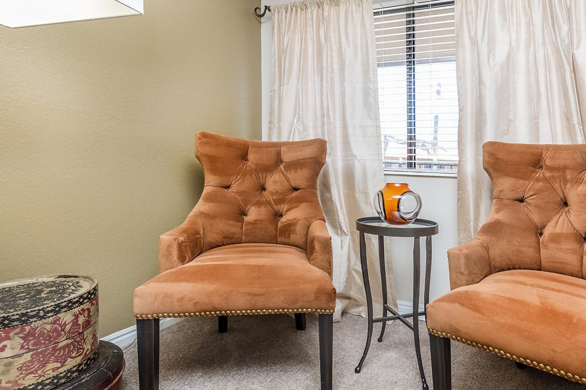 a living room with a leather chair