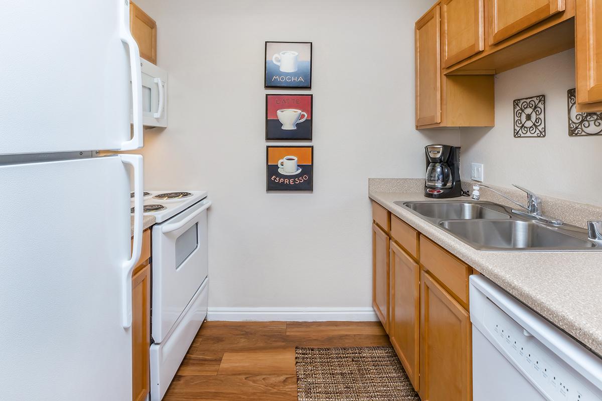 a kitchen with a sink and a refrigerator