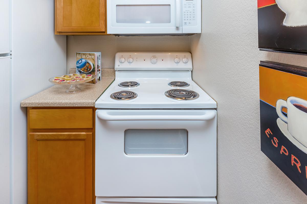 a stove top oven sitting inside of a kitchen