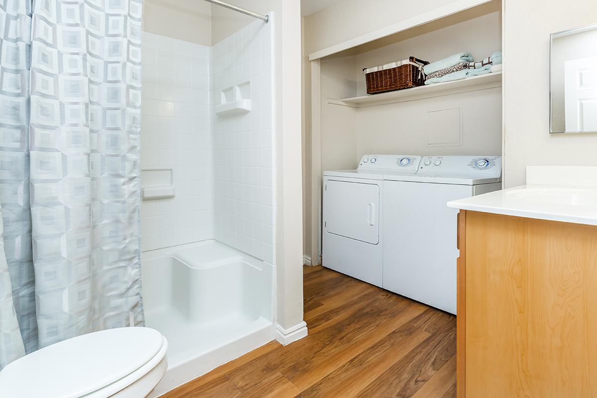 a large white tub next to a sink