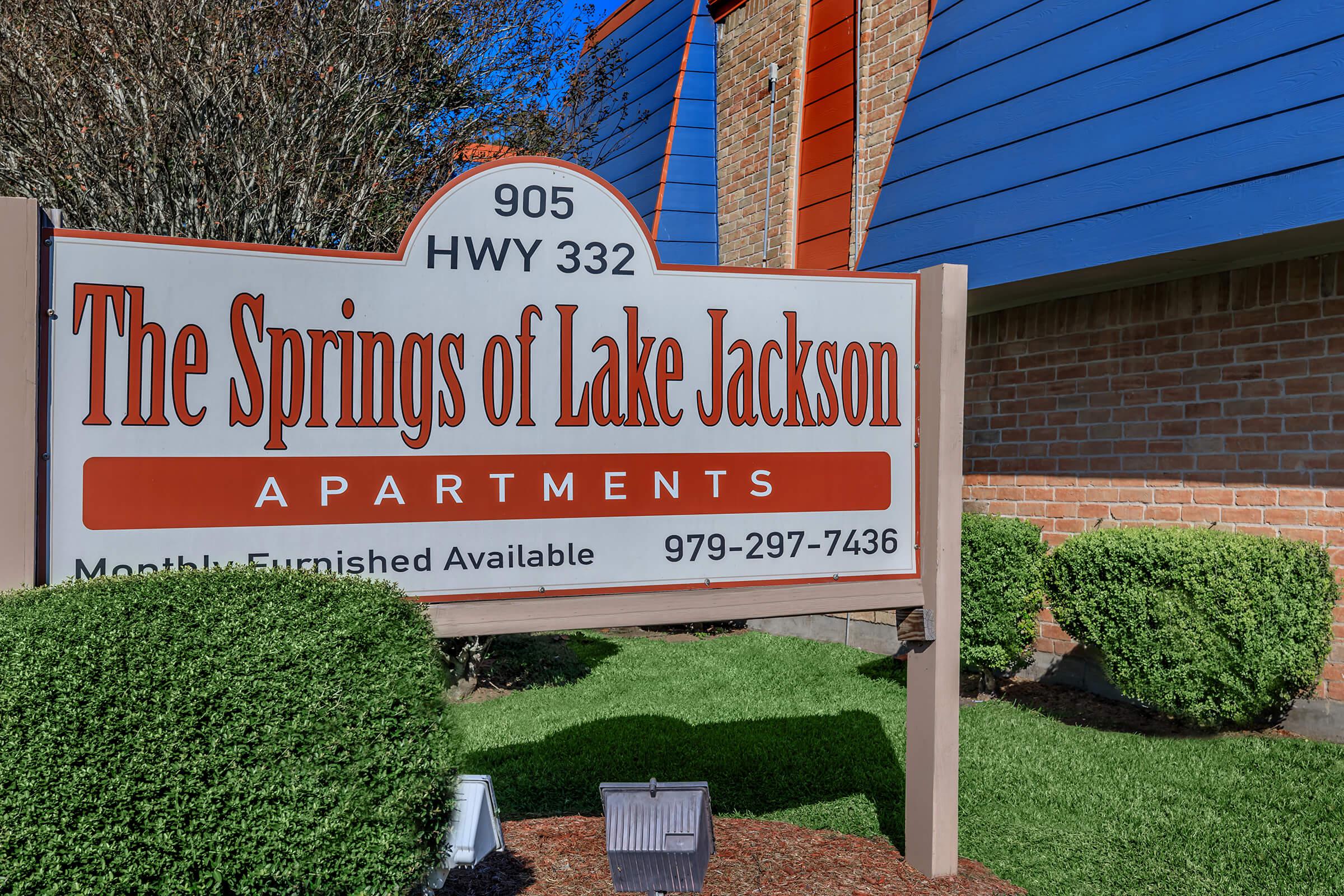 a sign in front of a brick building