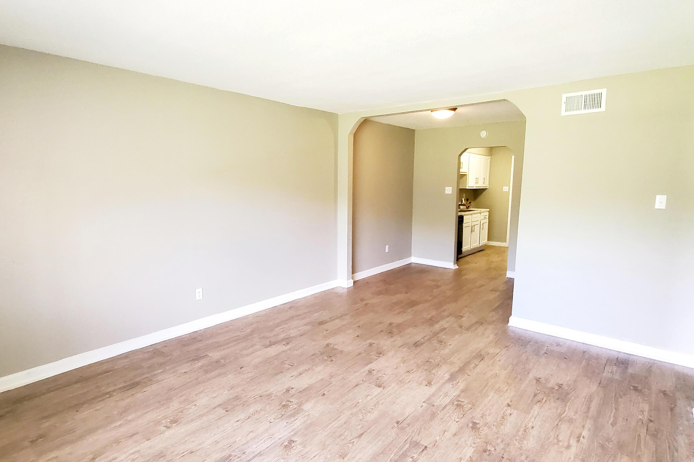 a bedroom with a wood floor