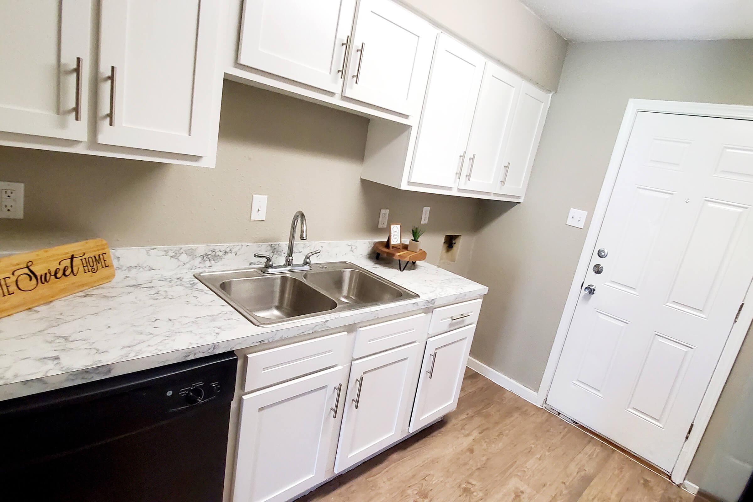 a kitchen with a sink and a mirror