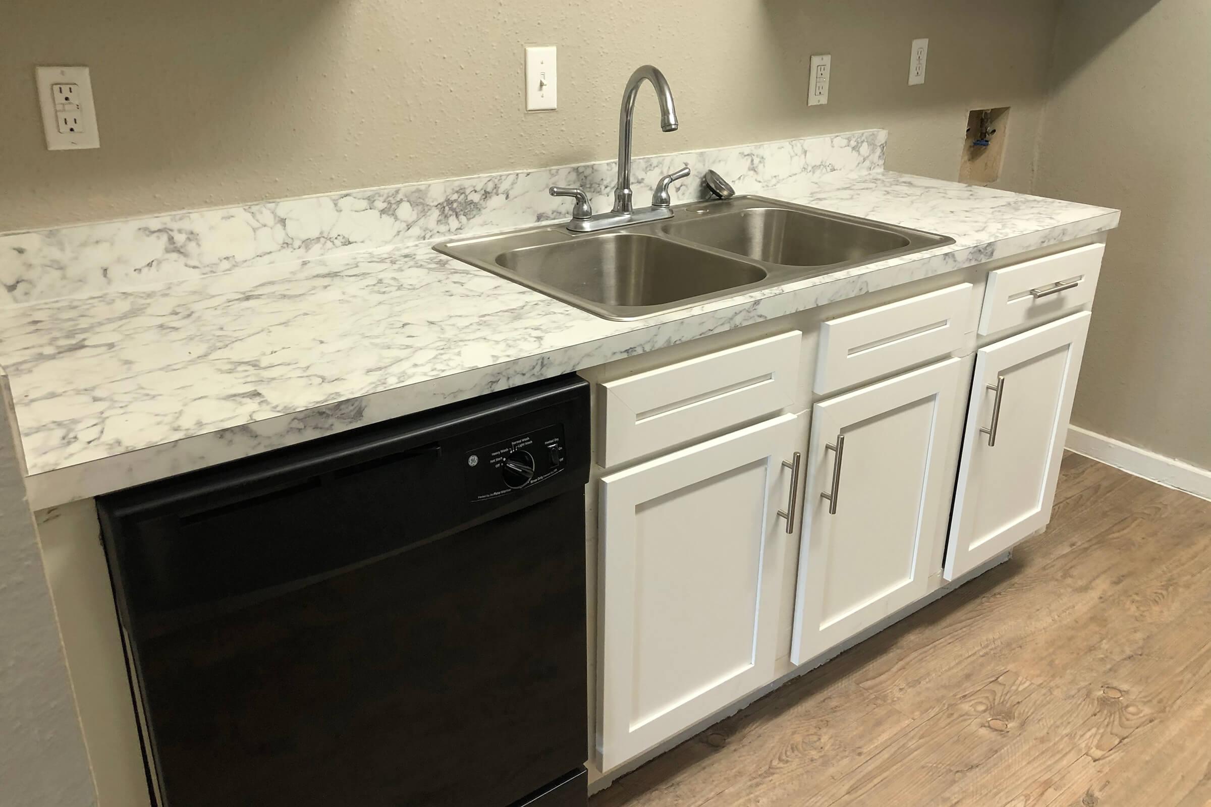 a kitchen with a sink and a mirror