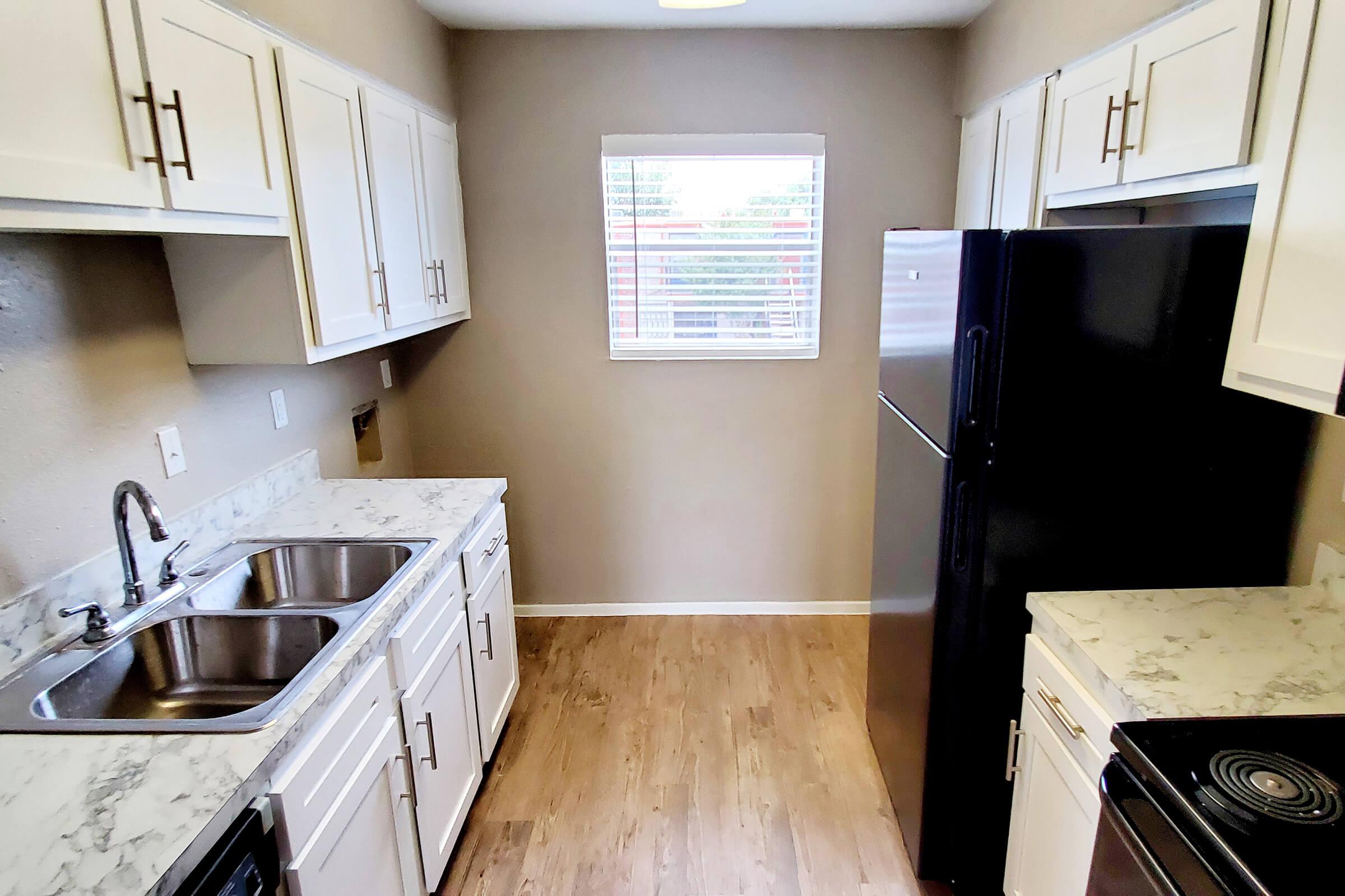 a stove top oven sitting inside of a kitchen